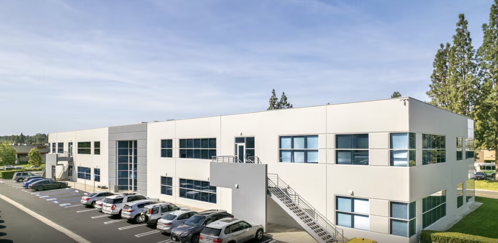 Side view of the new office building and its parking lot