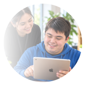 Young adult using a tablet with a mentor
