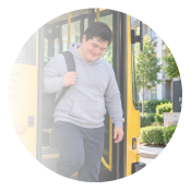 Young adult stepping off a school bus
