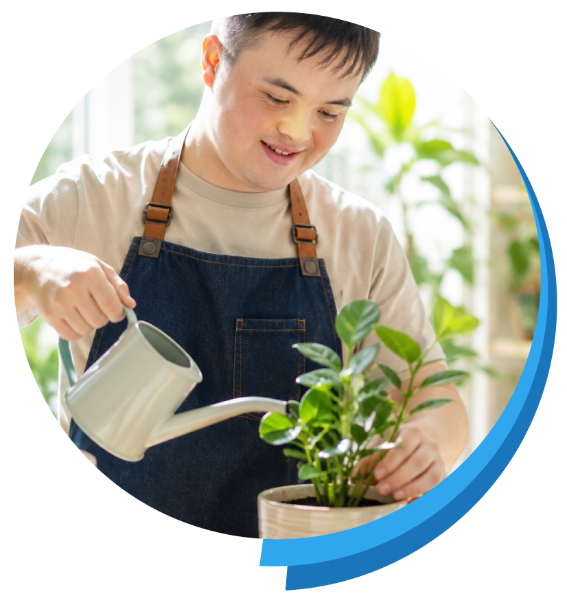 Young adult in the program watering a plant